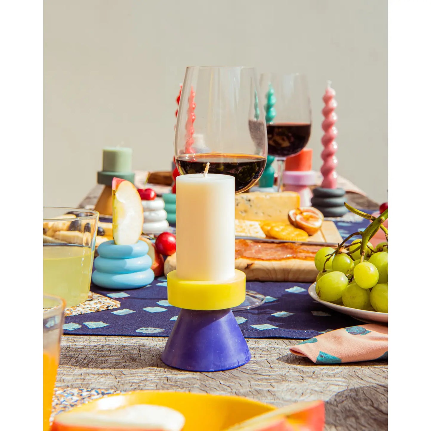 Yod + Co. Tall Stack Candle - White / Yellow / Blue. On table